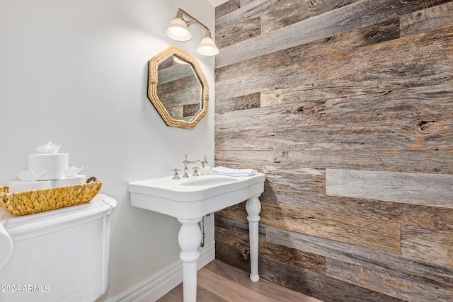bathroom featuring toilet and wood finished floors