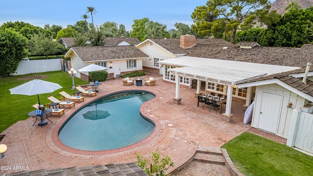 view of swimming pool featuring a yard, a fenced in pool, a patio, and fence