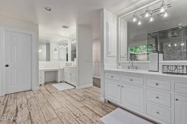 full bathroom with vanity, wood finished floors, and visible vents