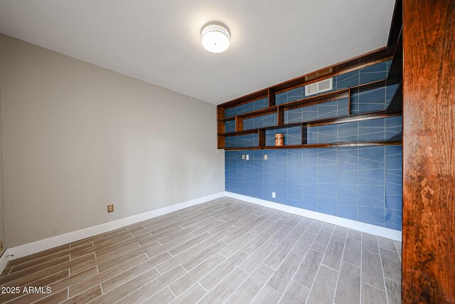 6533 N 7th Ave Unit 18, Phoenix, AZ 85013 - unfurnished room with baseboards and wood finished floors