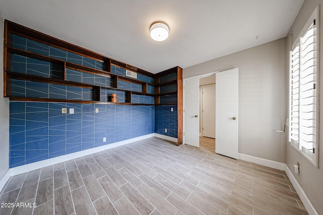 6533 N 7th Ave Unit 18, Phoenix, AZ 85013 - unfurnished bedroom featuring baseboards and wood finished floors
