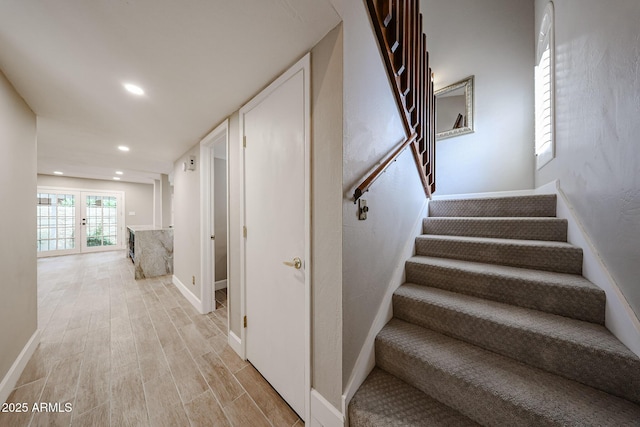 6533 N 7th Ave Unit 18, Phoenix, AZ 85013 - stairway featuring wood finished floors, french doors, baseboards, and recessed lighting