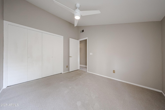 6533 N 7th Ave Unit 18, Phoenix, AZ 85013 - unfurnished bedroom with light carpet, a closet, baseboards, and lofted ceiling
