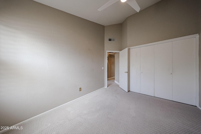 6533 N 7th Ave Unit 18, Phoenix, AZ 85013 - unfurnished bedroom featuring light carpet, a closet, baseboards, a ceiling fan, and high vaulted ceiling