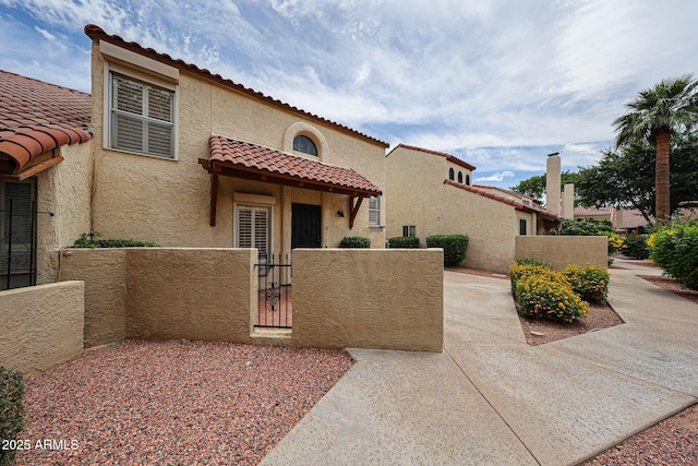 6533 N 7th Ave Unit 18, Phoenix, AZ 85013 - mediterranean / spanish house with stucco siding, a gate, and a tile roof