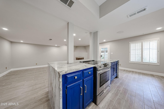 6533 N 7th Ave Unit 18, Phoenix, AZ 85013 - kitchen featuring electric range, blue cabinetry, open floor plan, light wood finished floors, and baseboards