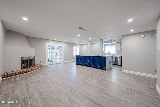 6533 N 7th Ave Unit 18, Phoenix, AZ 85013 - unfurnished living room featuring recessed lighting, baseboards, a large fireplace, and light wood-style flooring