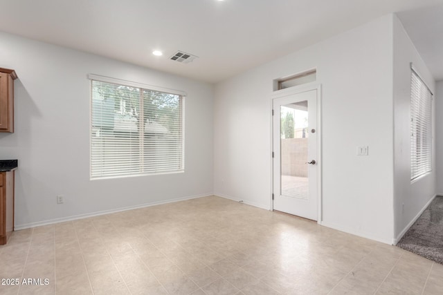 unfurnished room featuring healthy amount of natural light, recessed lighting, and baseboards