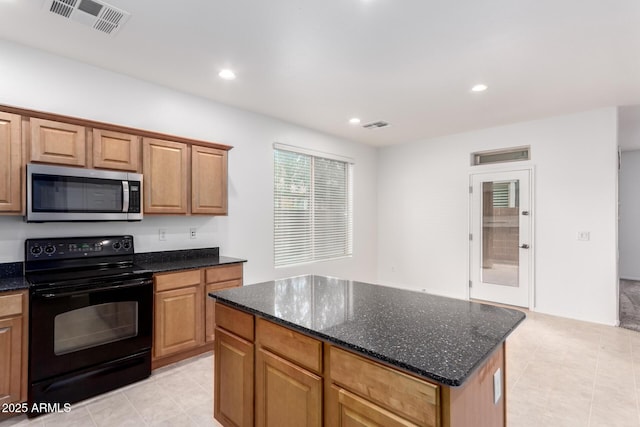 kitchen featuring stainless steel microwave, black electric range oven, light tile patterned flooring, dark stone countertops, and recessed lighting