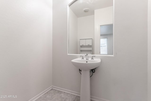 bathroom with baseboards and a sink
