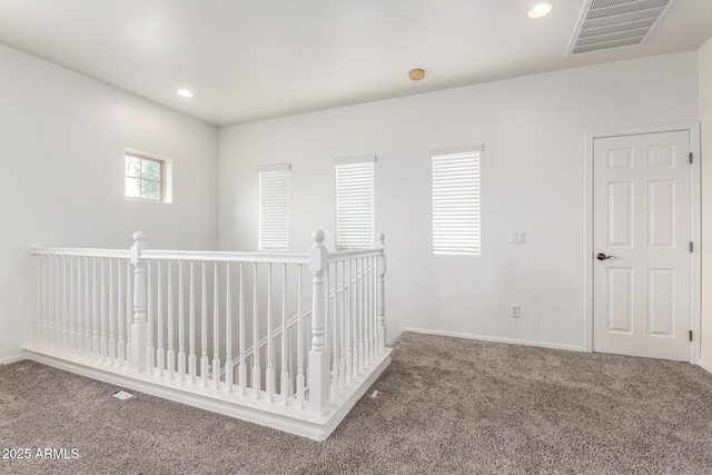 carpeted empty room featuring recessed lighting and baseboards