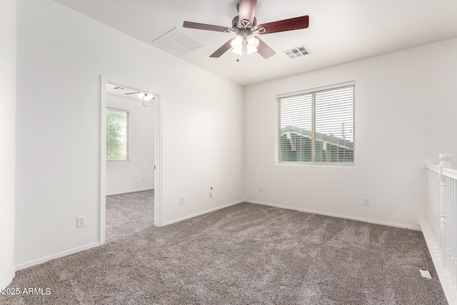 unfurnished room featuring carpet floors, ceiling fan, and baseboards