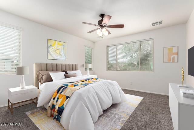 carpeted bedroom with multiple windows, baseboards, and a ceiling fan