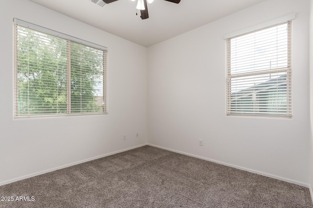 unfurnished room featuring a ceiling fan, carpet floors, and baseboards