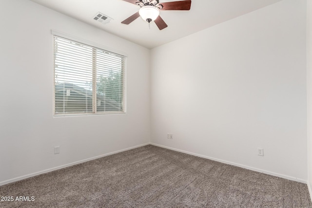 spare room with ceiling fan, carpet floors, and baseboards