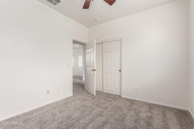 unfurnished bedroom featuring carpet floors, a closet, and baseboards