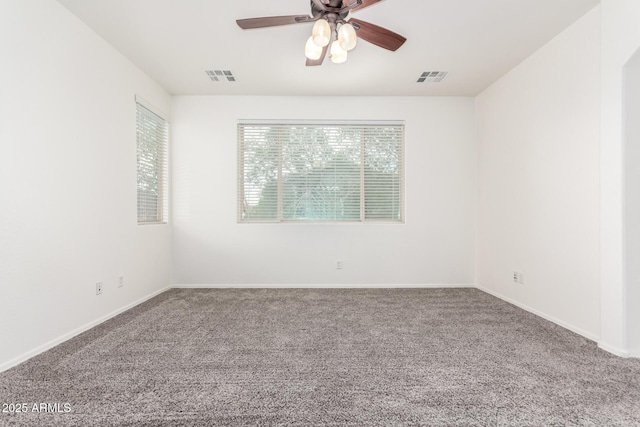 unfurnished room featuring carpet flooring, ceiling fan, and baseboards