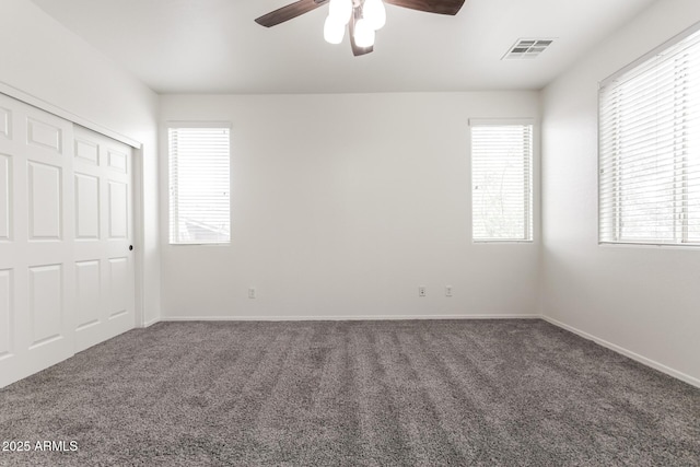 unfurnished bedroom with carpet floors, baseboards, ceiling fan, and a closet