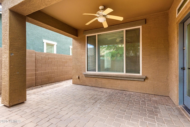 view of patio / terrace featuring ceiling fan and fence