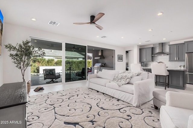 tiled living room with ceiling fan