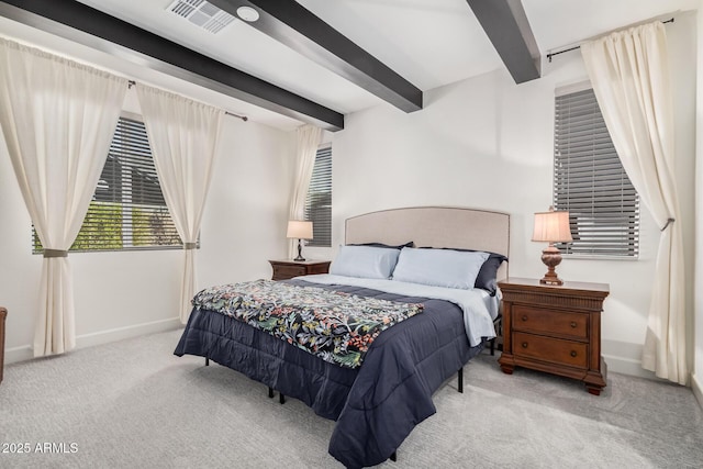 bedroom with beamed ceiling and light carpet