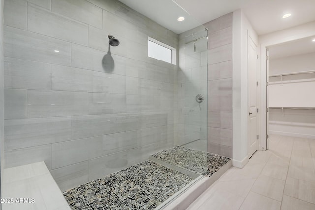 bathroom featuring a tile shower and tile patterned floors