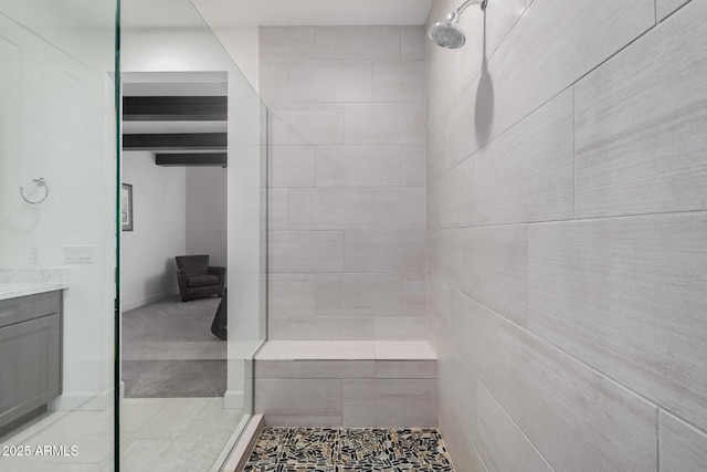 bathroom featuring vanity and a tile shower