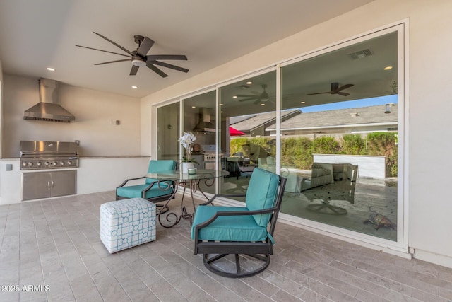 view of patio / terrace featuring ceiling fan, an outdoor kitchen, and area for grilling