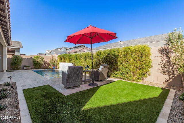 view of yard with a fenced in pool and a patio