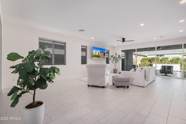 living room featuring light tile patterned floors and ceiling fan