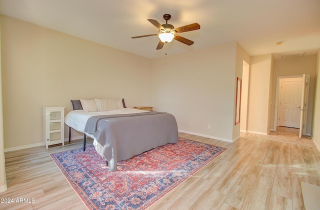 bedroom with ceiling fan and light hardwood / wood-style flooring