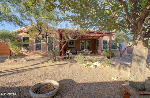 rear view of property featuring a patio area and a pergola