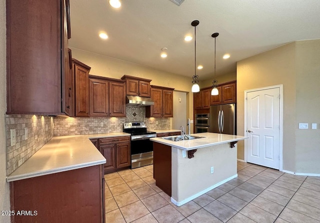 kitchen featuring sink, light tile patterned floors, appliances with stainless steel finishes, backsplash, and an island with sink