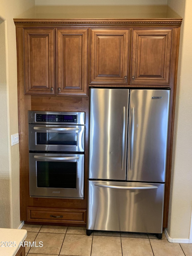 kitchen featuring light tile patterned flooring and appliances with stainless steel finishes