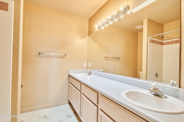 bathroom with a shower, vanity, and toilet