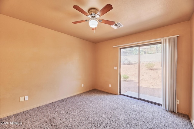 carpeted spare room with ceiling fan