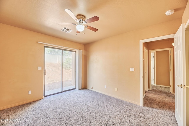 carpeted spare room featuring ceiling fan