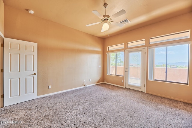 carpeted empty room featuring ceiling fan