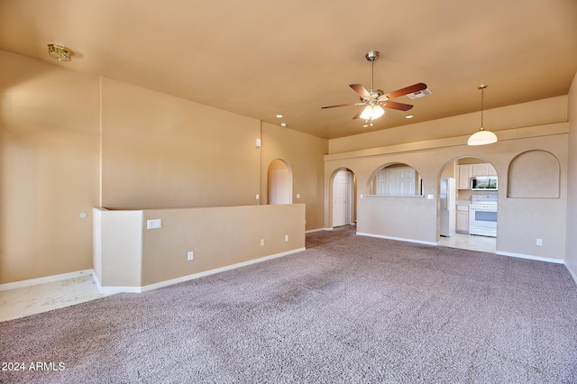 unfurnished living room with carpet flooring and ceiling fan