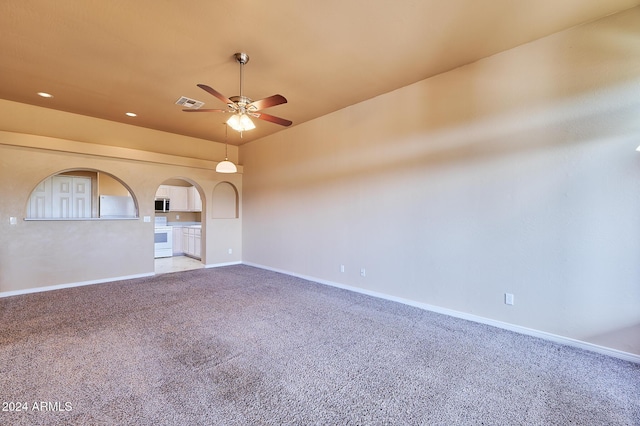 spare room with carpet floors and ceiling fan