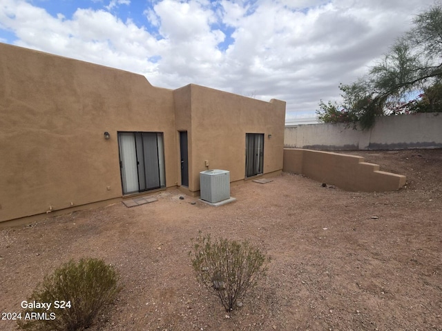 rear view of property featuring cooling unit