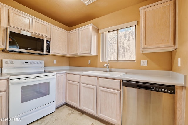 kitchen featuring light brown cabinetry, sink, and appliances with stainless steel finishes