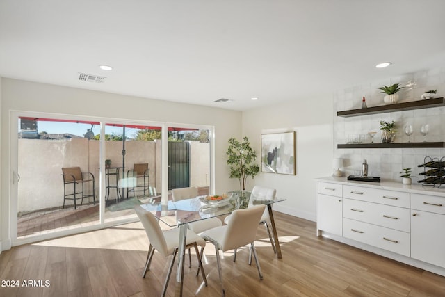 dining space with light hardwood / wood-style floors