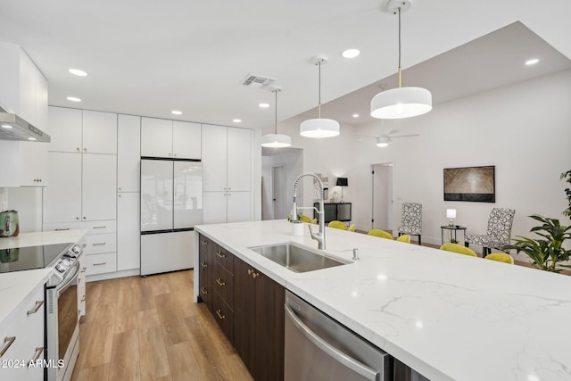 kitchen with dark brown cabinetry, hanging light fixtures, sink, light wood-type flooring, and appliances with stainless steel finishes