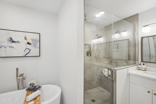 bathroom featuring vanity and independent shower and bath