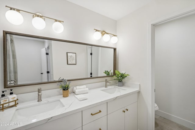 bathroom featuring vanity and toilet