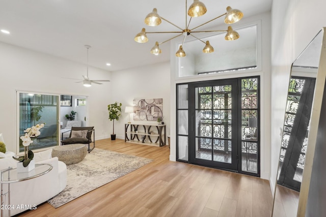 entryway featuring hardwood / wood-style flooring and ceiling fan with notable chandelier