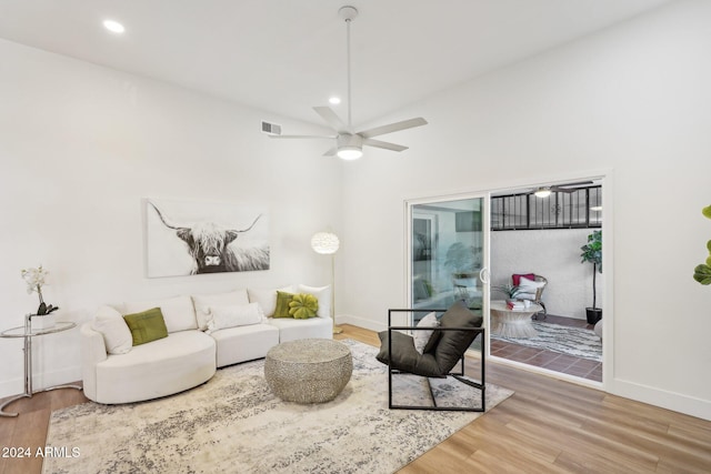 living room with hardwood / wood-style floors and ceiling fan