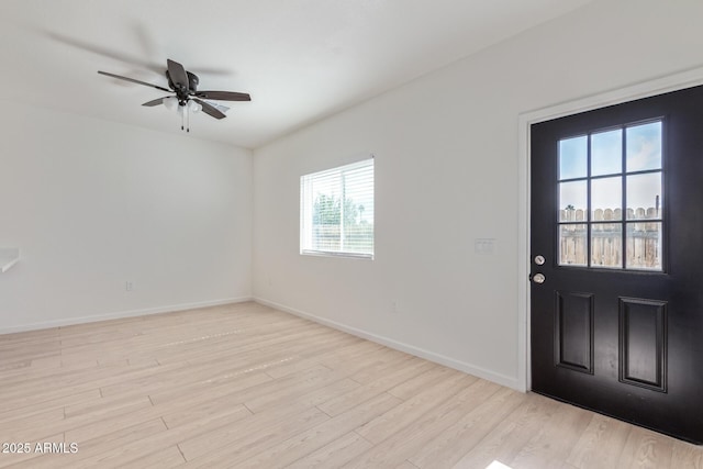 entrance foyer with a ceiling fan, baseboards, and wood finished floors