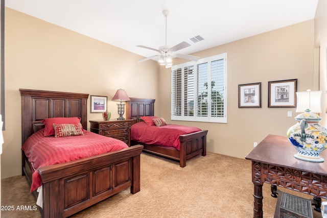 bedroom with visible vents, ceiling fan, and light carpet